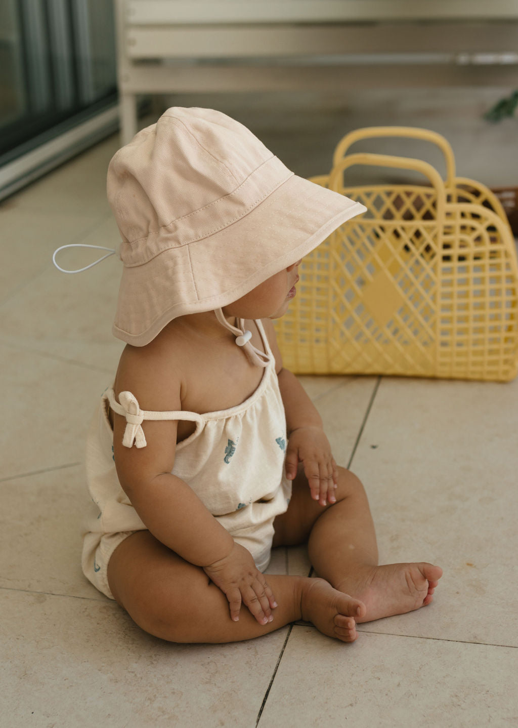 Acorn Baby Vanilla Wide Brim Infant Hat - side view on baby