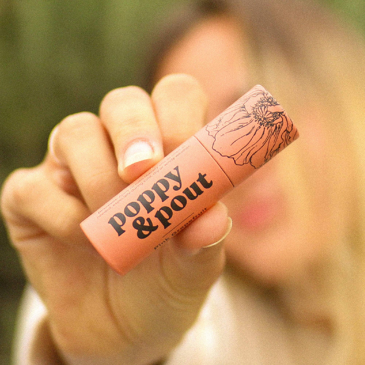 Poppy and Pout Pink Grapefruit lip balm - styled flat lay