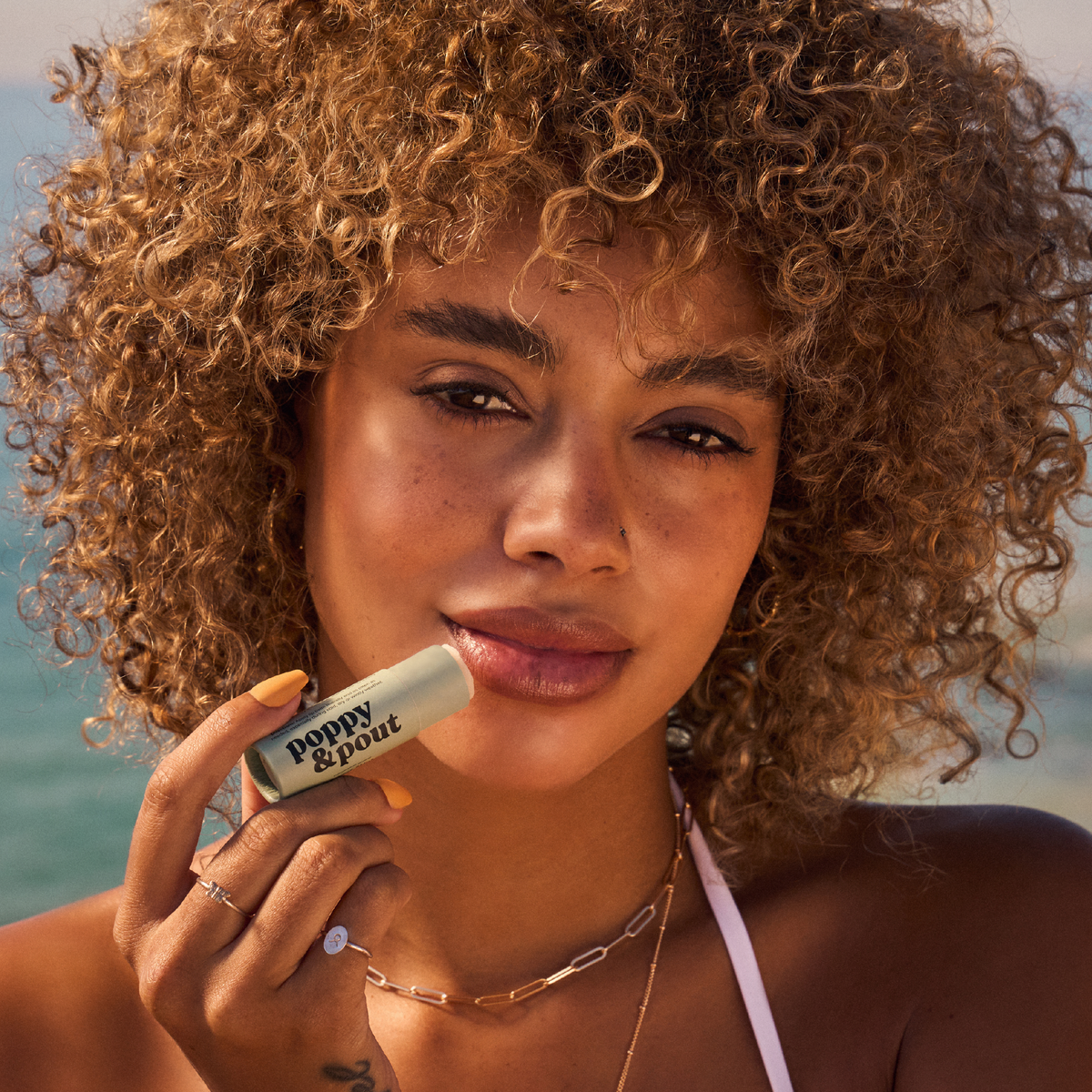 Poppy and Pout Sweet Mint lip balm - model applying