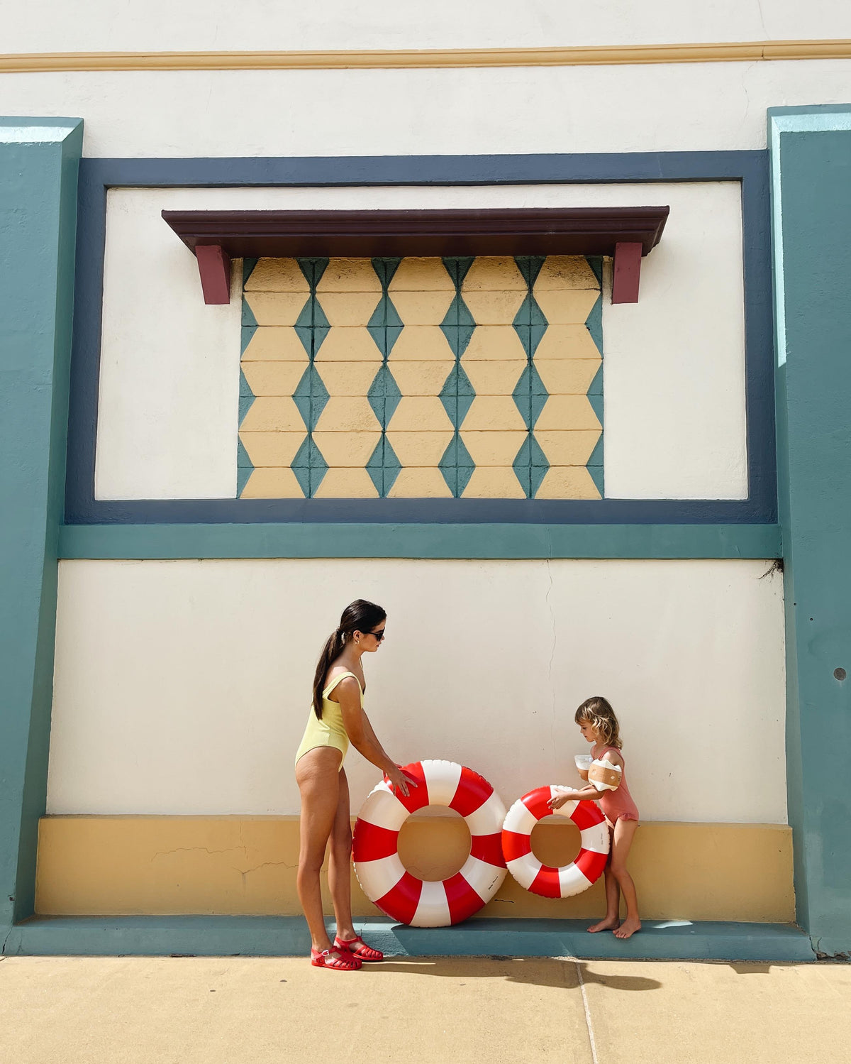 Petites Pommes - Sally Swim Ring - Signal Red 90cm (6+ years) — styled lifestyle shot