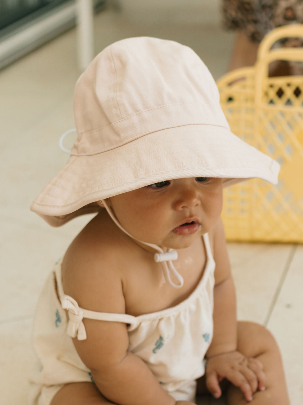 Acorn Baby Vanilla Wide Brim Infant Hat - front view on baby