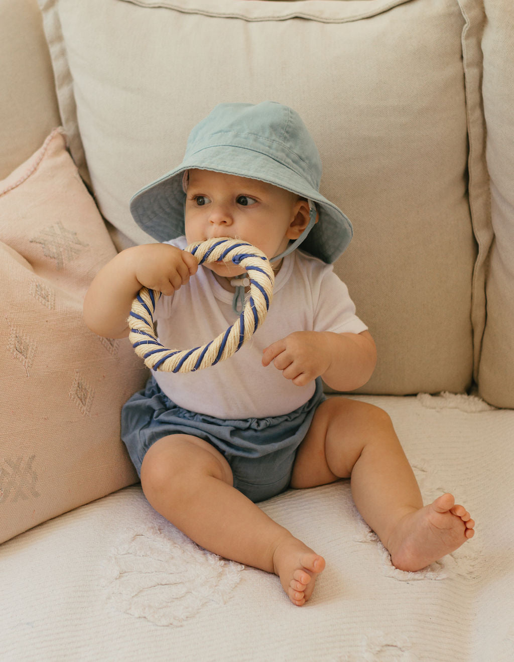 Acorn Baby Blue Wide Brim Infant Hat - front view on baby