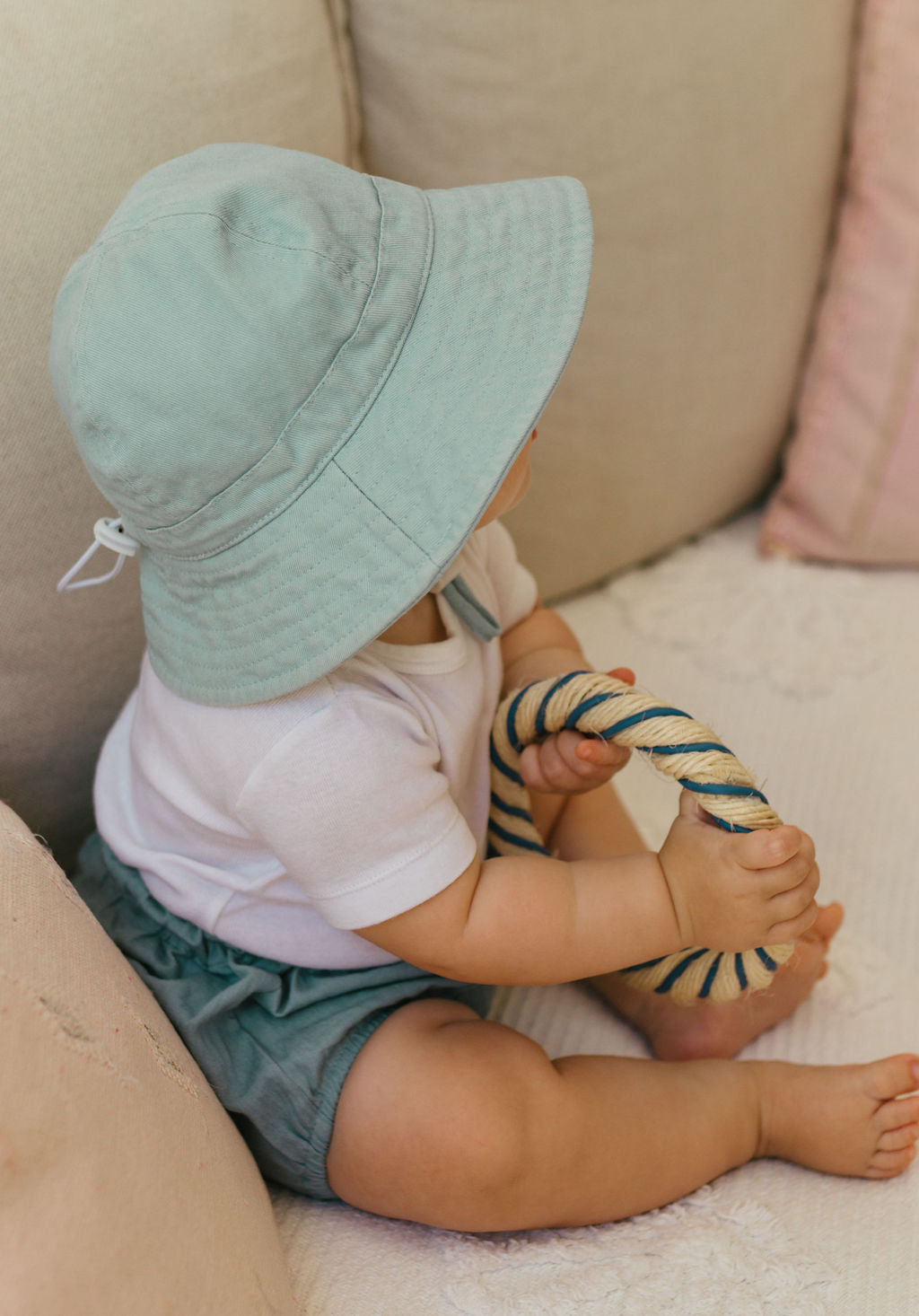 Acorn Baby Blue Wide Brim Infant Hat - side view on baby