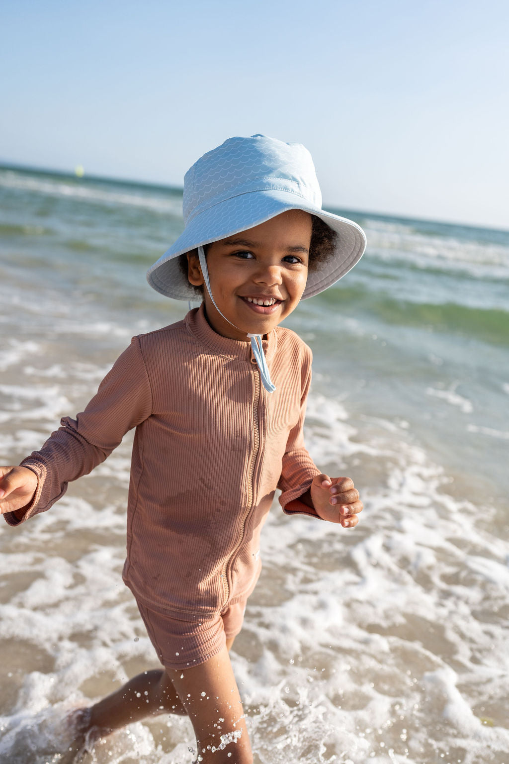 Acorn Blue Waves Wide Brim Swim Hat - front view on child