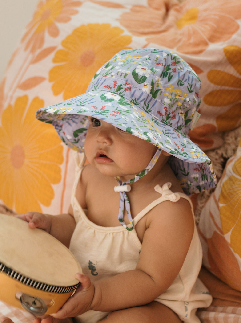 Acorn Baby Chateau Blooms Wide Brim Infant Hat - front view on baby
