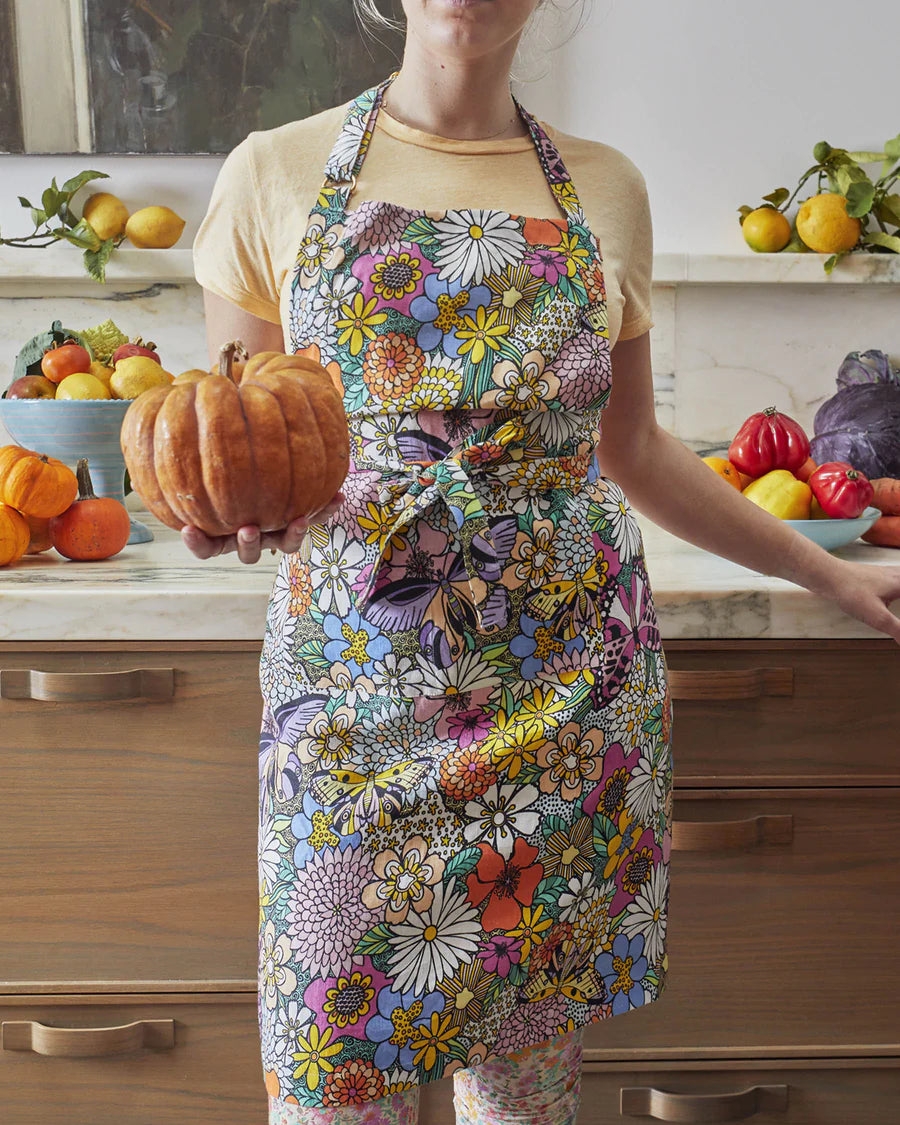 Kip and Co Bliss Floral linen apron - model wearing in kitchen